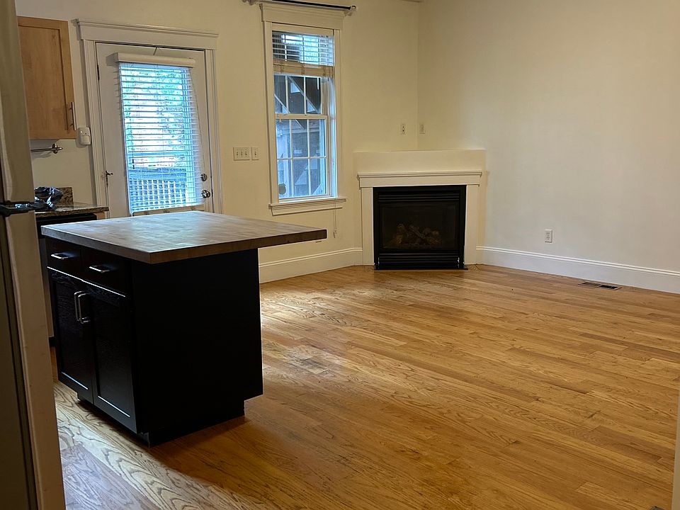 Large Kitchen/Dining/Living area with high ceilings and gas fireplace