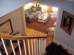 Nice view of living room from the curved staircase. Window at top of staircase allows natural light 