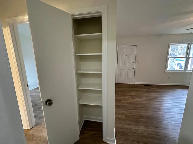 This photo is taken back in the middle of the home. The door is the entry to the home, the room on the right is the living room. The closet can be used as a pantry.