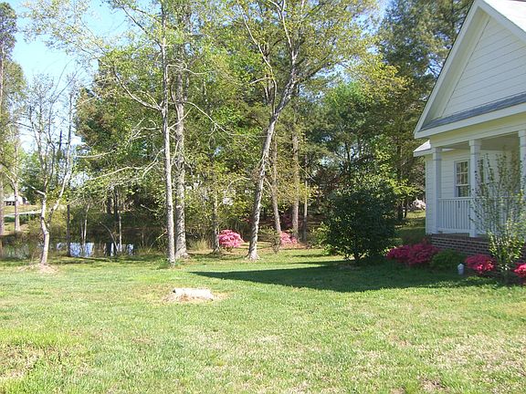 view of acre wooded lot with pond