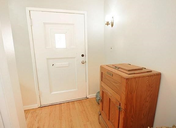 Ample size entry foyer with two coat closets and original hardwood floors.