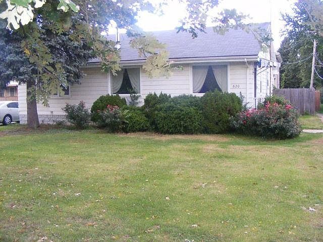 Front of House 620 N State Str- House goes way back The 2 Windows to the right are family room, the one to the left is the Master Bed- Lots of light all the way around the house