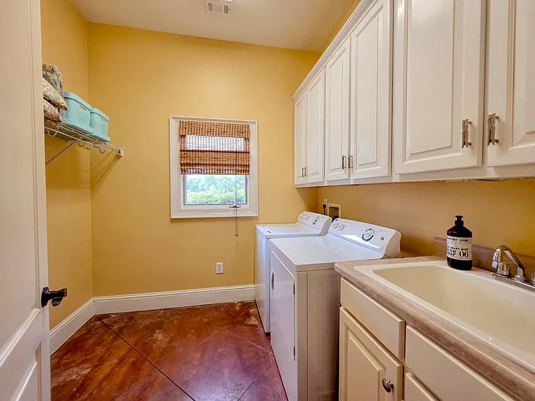 Laundry room with utility sink, and storage cabinets