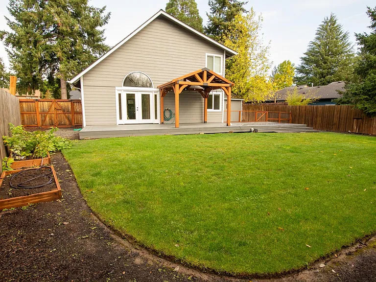View of the back yard (facing the back of the house) from the fence.