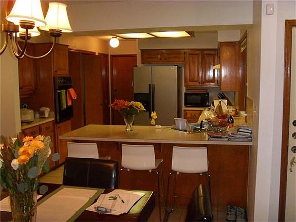 Kitchen is opem to living room. Has breakfast bar. All appli
