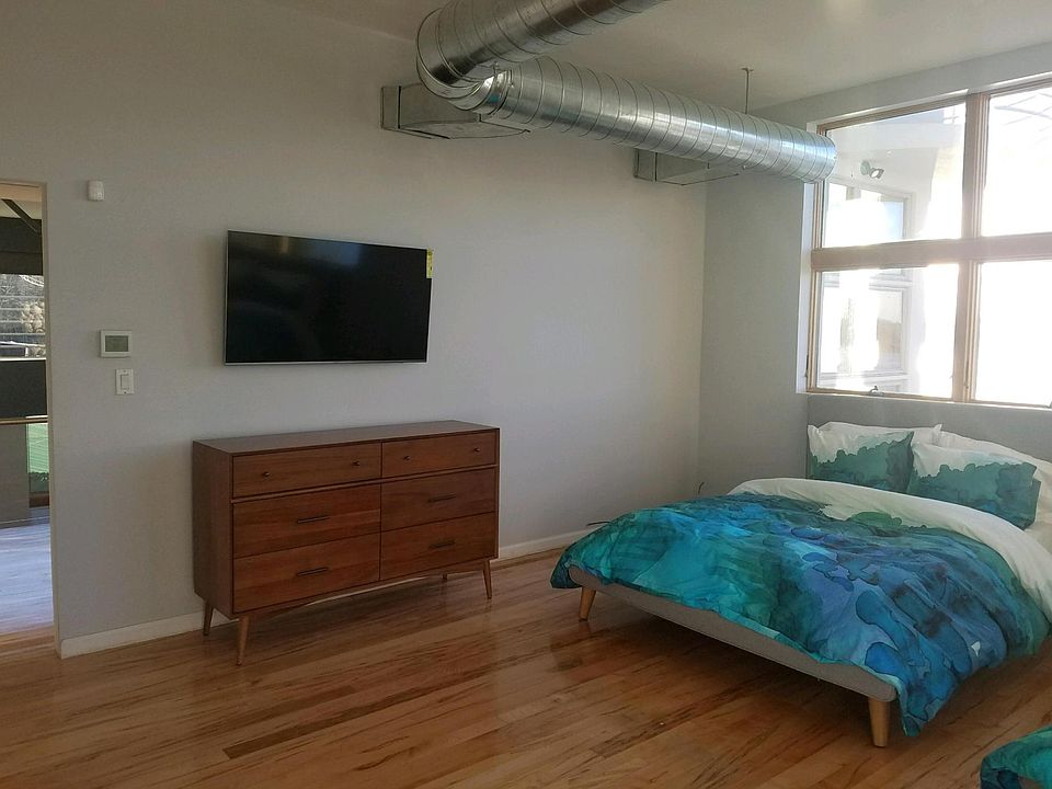 bedroom on 2nd floor with two full beds and flat screen tv; fully furnished