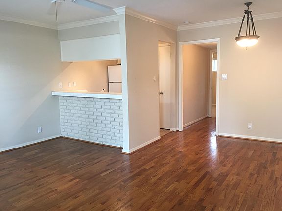 Living room and dining area: Lots of natural light, accent brick wall by bar