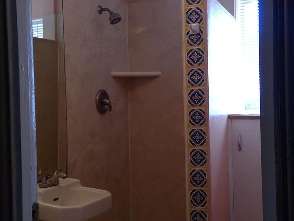 32" Sq shower, tile detail, storage.