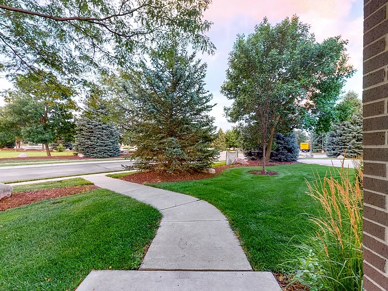 Lush landscaping and peaceful pathways make every stroll feel like a retreat.