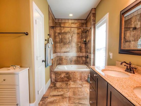 Spa like master bath, with jet tub and his + her sinks.