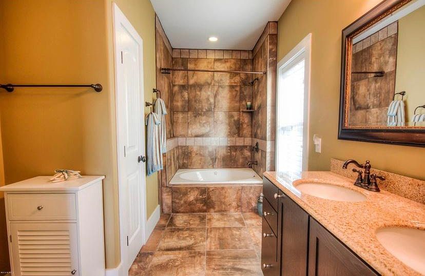 Spa like master bath, with jet tub and his + her sinks.