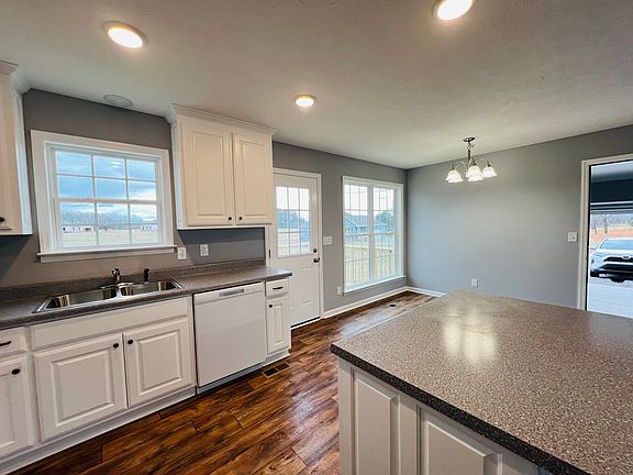 Kitchen with recessed lighting, an island and custom cabinetry.