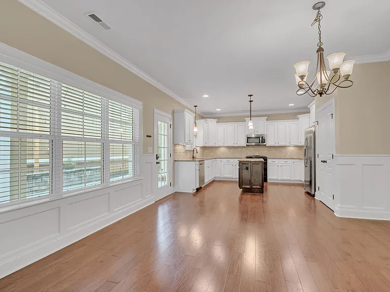 Dining room includes large windows overlooking the patio