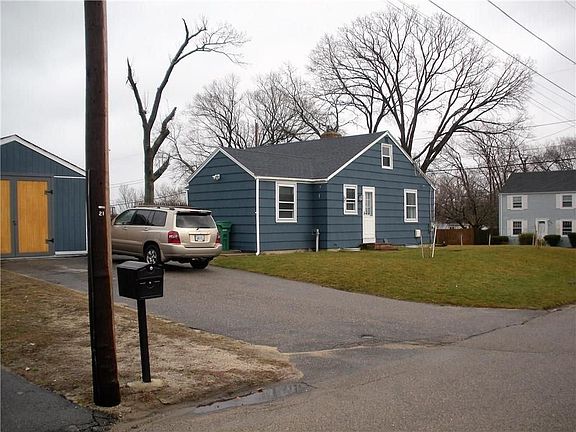 Extra wide driveway leading to shed/storage area.