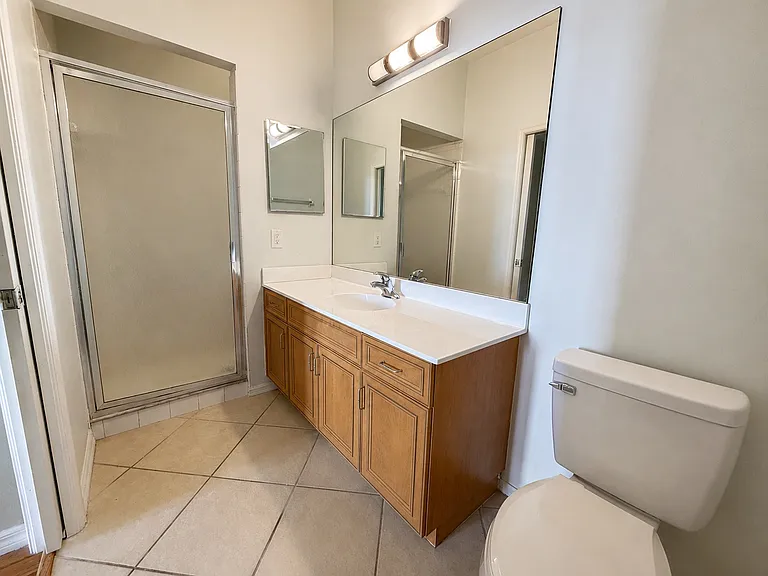 Private primary bathroom featuring a spacious vanity and walk-in shower