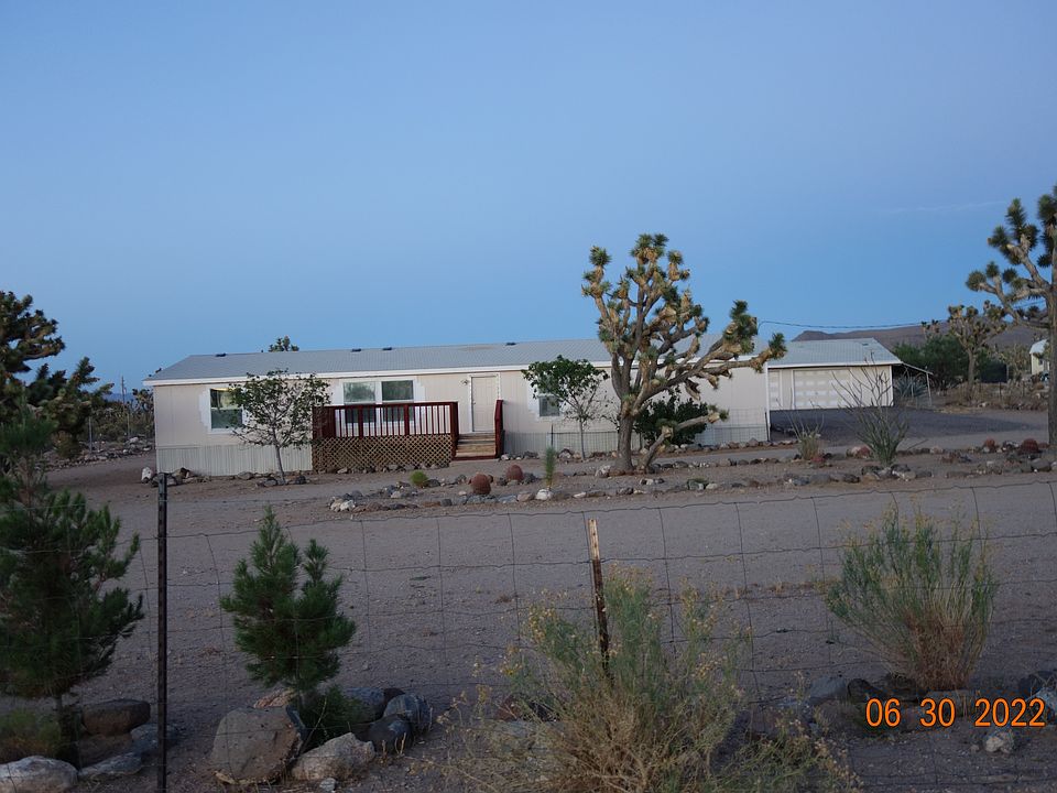 4 Bedroom / 2 Bath Doublewide on 2 Fully Fenced Acres in Nice Neighborhood ~ Water Haul Area Near Well, About 1 Mile off Paved Road.