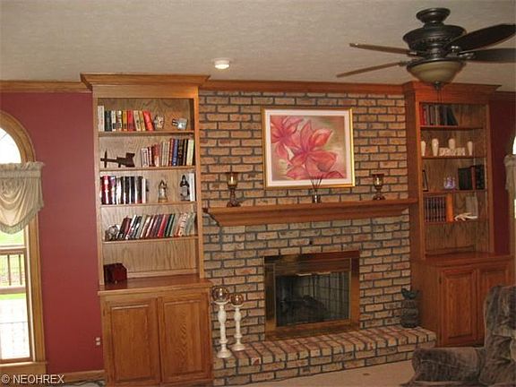 Family room's brick hearth/mantel--Lovely Built-in Bookcases