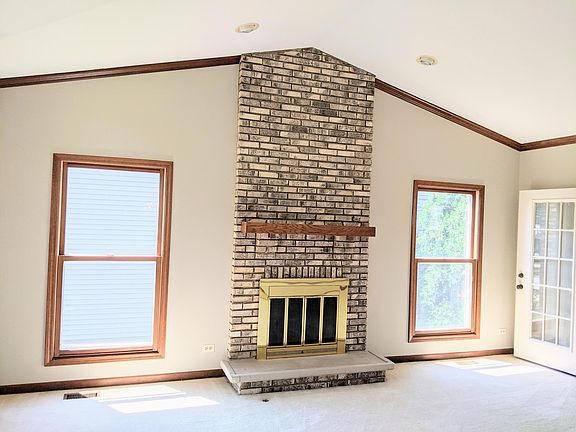 Living Room with cathedral ceiling and floor to ceiling fireplace