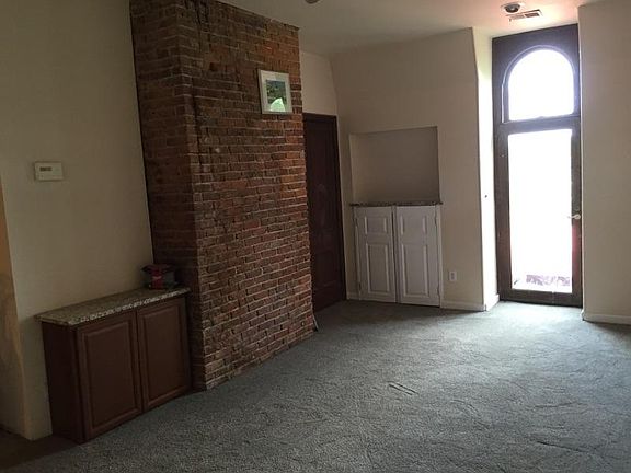 Living room with brick wall