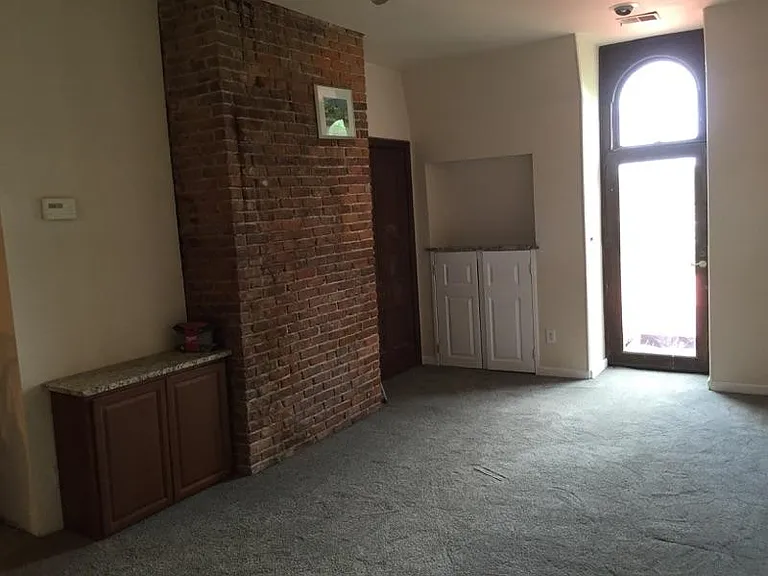 Living room with brick wall