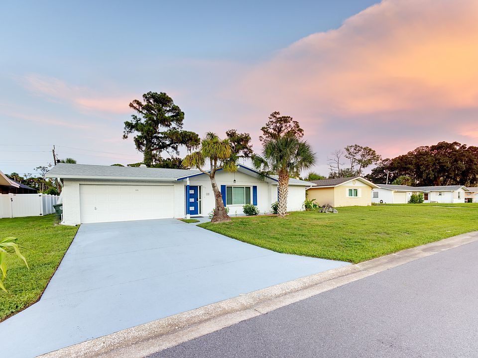 House front with 2-car wide drive way