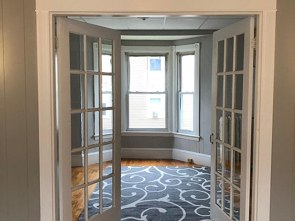 French doors to bedroom with bow window.