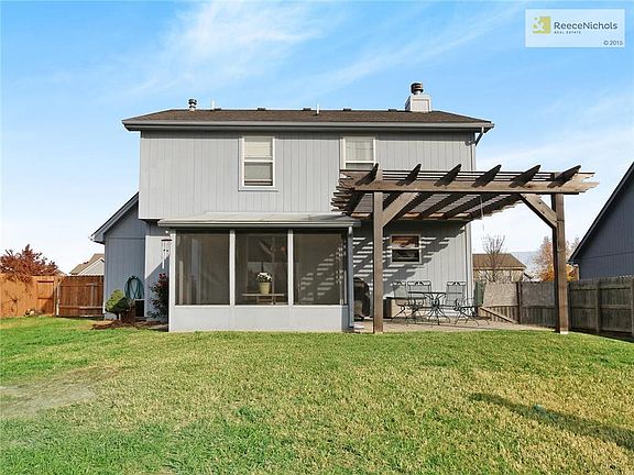 Large fenced backyard with pergola.