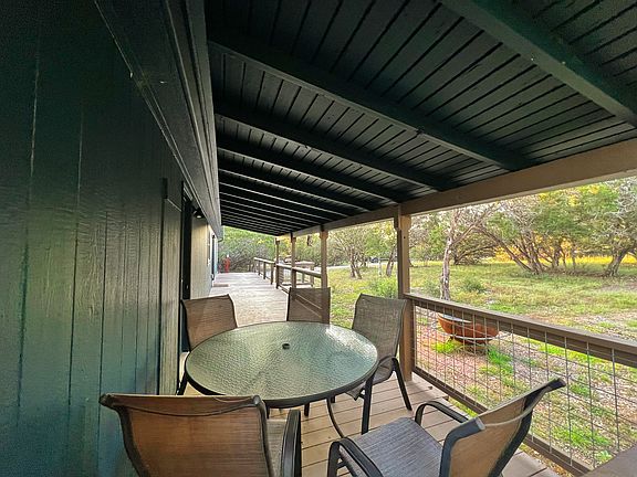 Covered porch with table and chairs for your early morning coffee in the country!