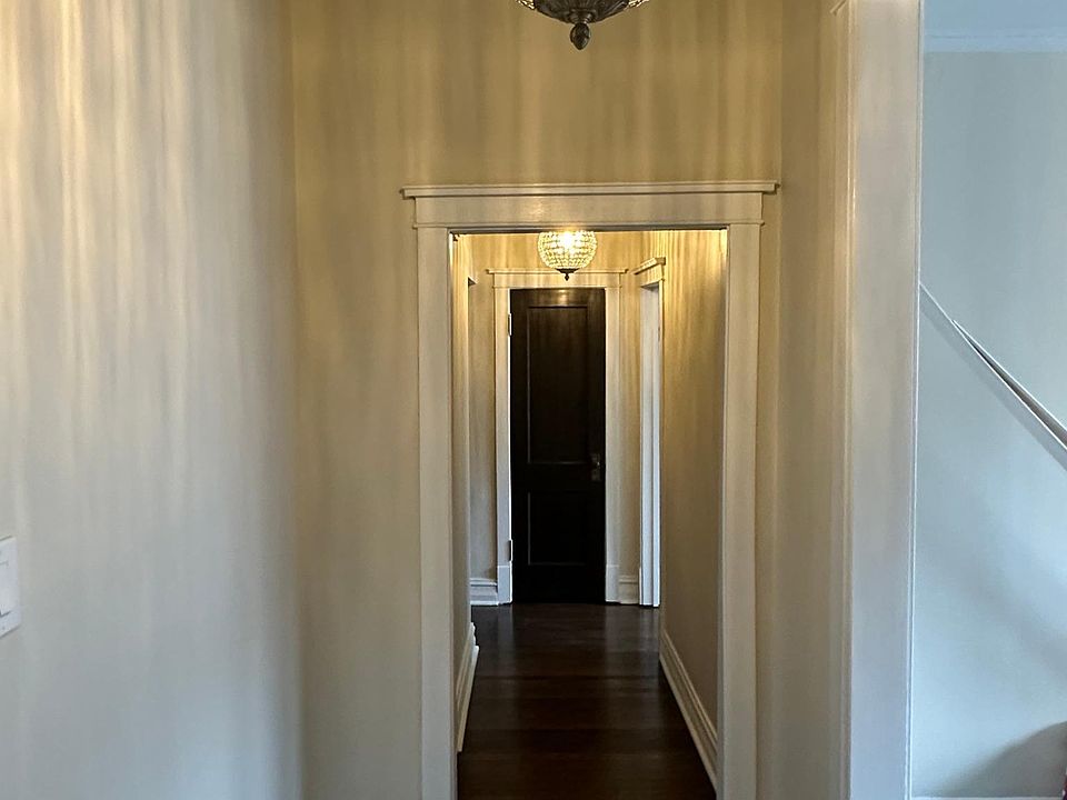 VIEW FROM FRONT DOOR - LONG HALL WITH CLOSET AT END