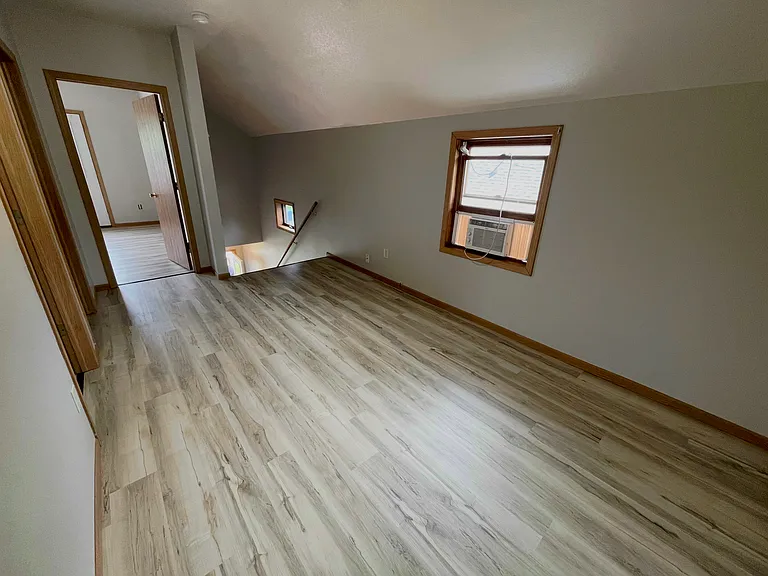 Bright hallway connecting the living spaces throughout this well-maintained front upper duplex.