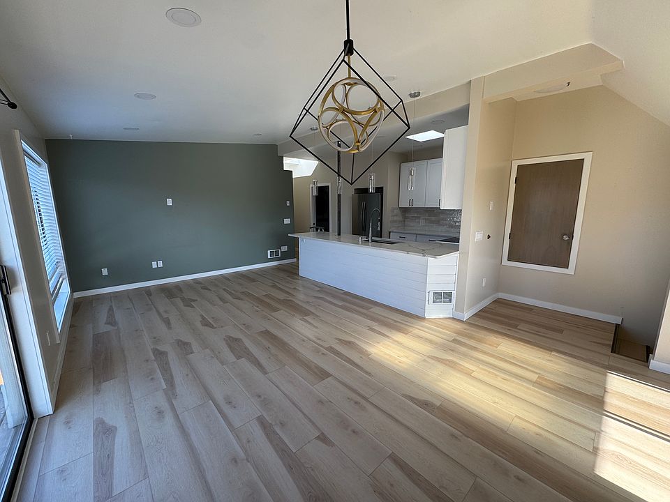 Living room, kitchen and coat closet from dining room
