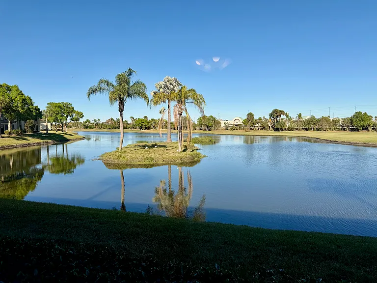 STUNNING lake and golf views to enjoy from the living room & primary bedroom!