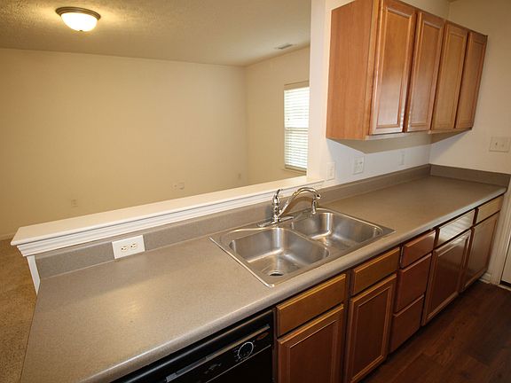 Kitchen features all black appliances, including over the counter microwave & smooth-top range.