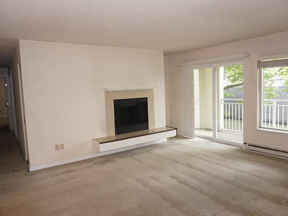 Living Room + Fireplace with Patio Area