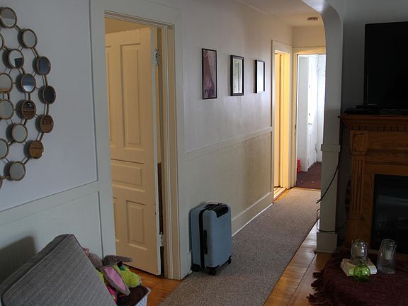 Hallway to back entrance and deck. Bathroom far left door.