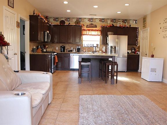 Kitchen has 42 inch wood cabinets. Stainless steel appliances. Granite counter tops. Kitchen island.