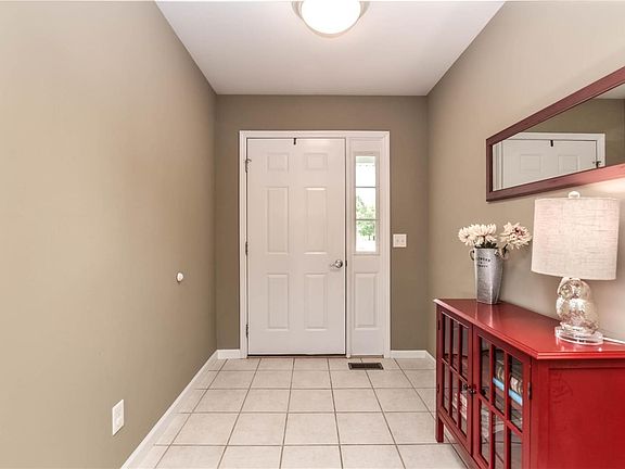 Covered front porch leads to tiled entry foyer