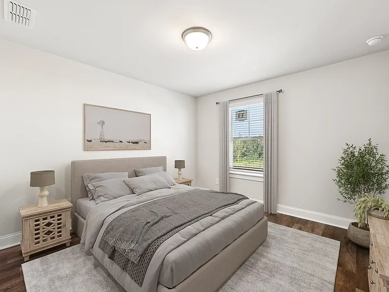 Secondary bedroom with queen size bed and large window letting in a ton of natural light.