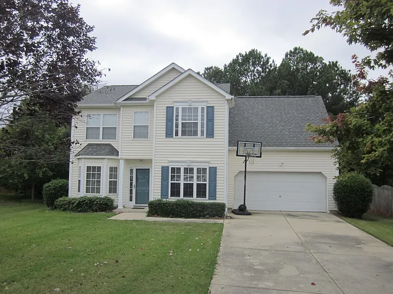 Front yard with professional landscaping included.