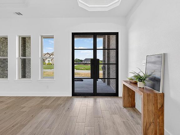 Doorway featuring wood finished floors and baseboards