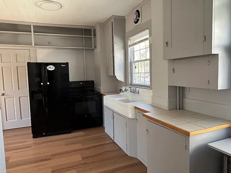 Kitchen with self clean electric stove 2 years old and Refrigerator