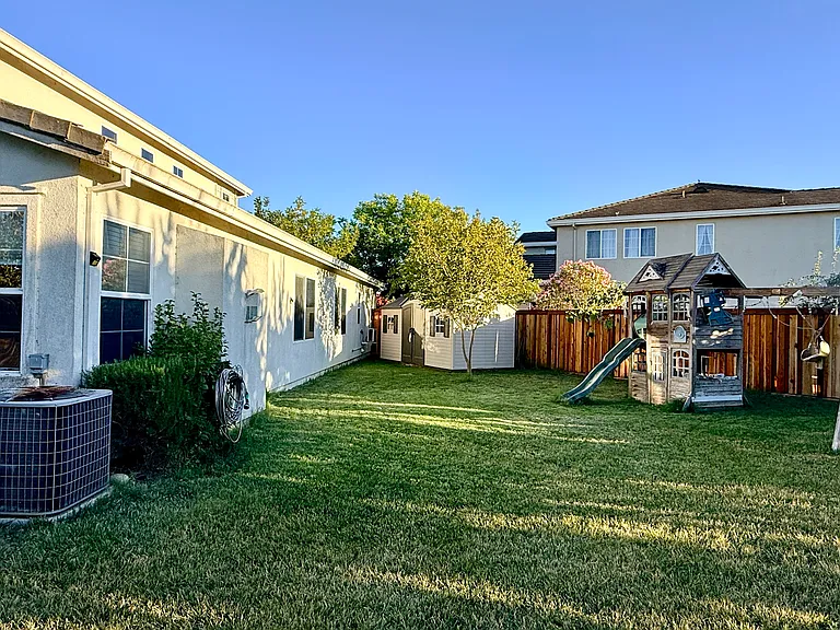 Backyard with a kids play area and shed