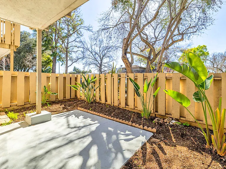 Serene outdoor patio space with garden views.