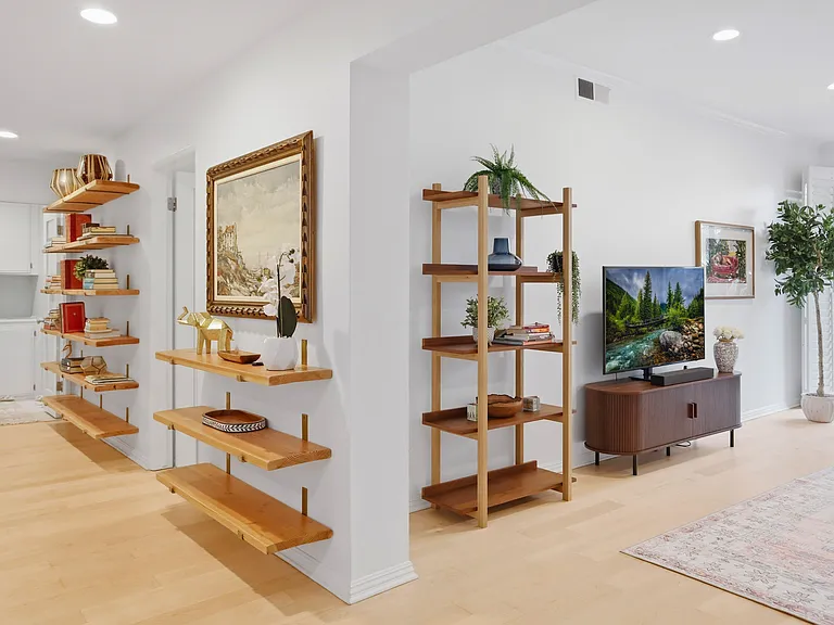Bedroom hallway with library of books.