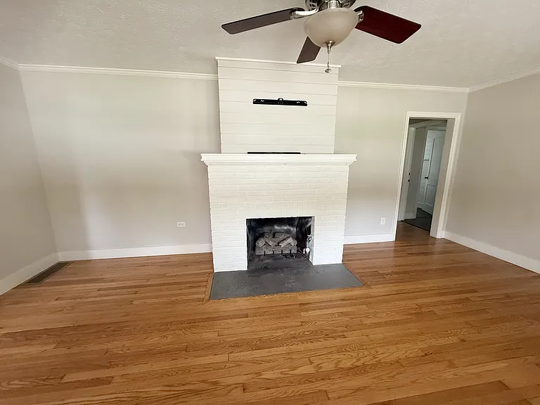 Fireplace with hallway to master and bedroom 2