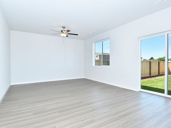 The living area is filled with natural lighting from sliding glass doors and many windows.
