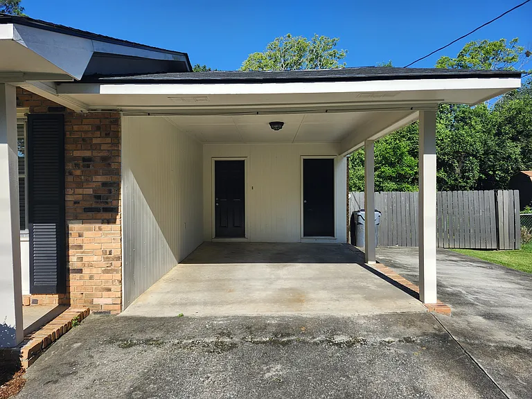Carport Area: Entrance door on left and storage door in right! Additional parking area on the right of carport.