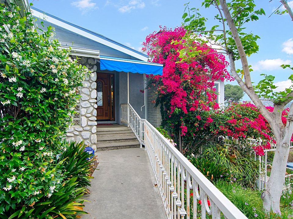 Walkway to entry with flower garden on your right.