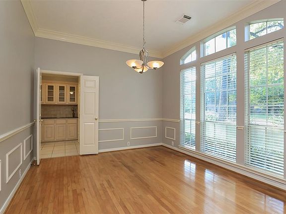 Formal Dining Room has Double Crown Molding, Updated Chandelier and French Door Access to Butler's Pantry.