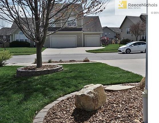 Landscaping extends around the sides of the home.